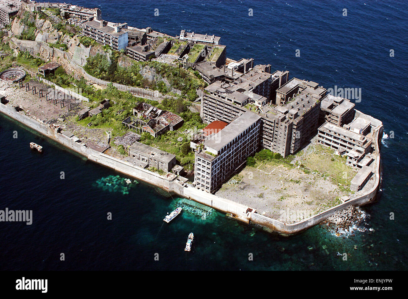 Hashima, Nagasaki, Japan. Also known as Gunkanjima (battleship island), it used to have coal mines and housed over 4,000 inhabitants. After it was abandoned in the mid 20th century the town turned into a ghost town. Stock Photo