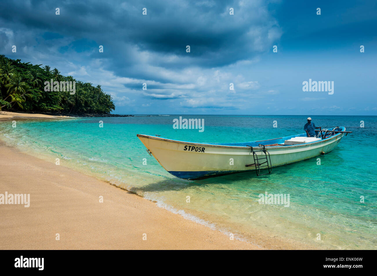 Little motorboat in the turquoise waters of Banana beach, UNESCO Biosphere Reserve, Principe, Sao Tome and Principe Stock Photo