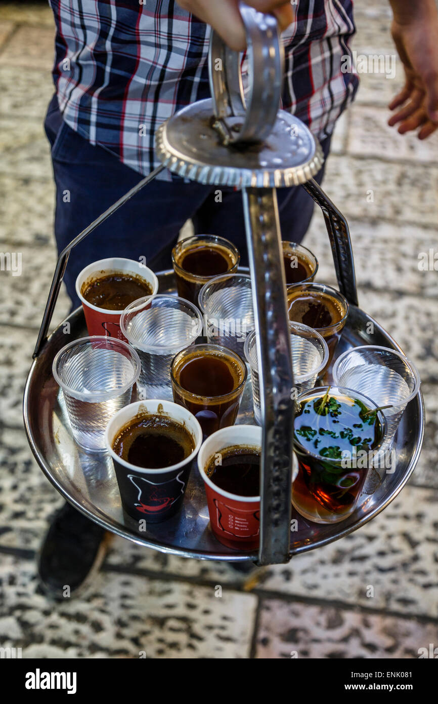 Young man holding a tray with coffee, tea and water in old city, Jerusalem, Israel, Middle East Stock Photo