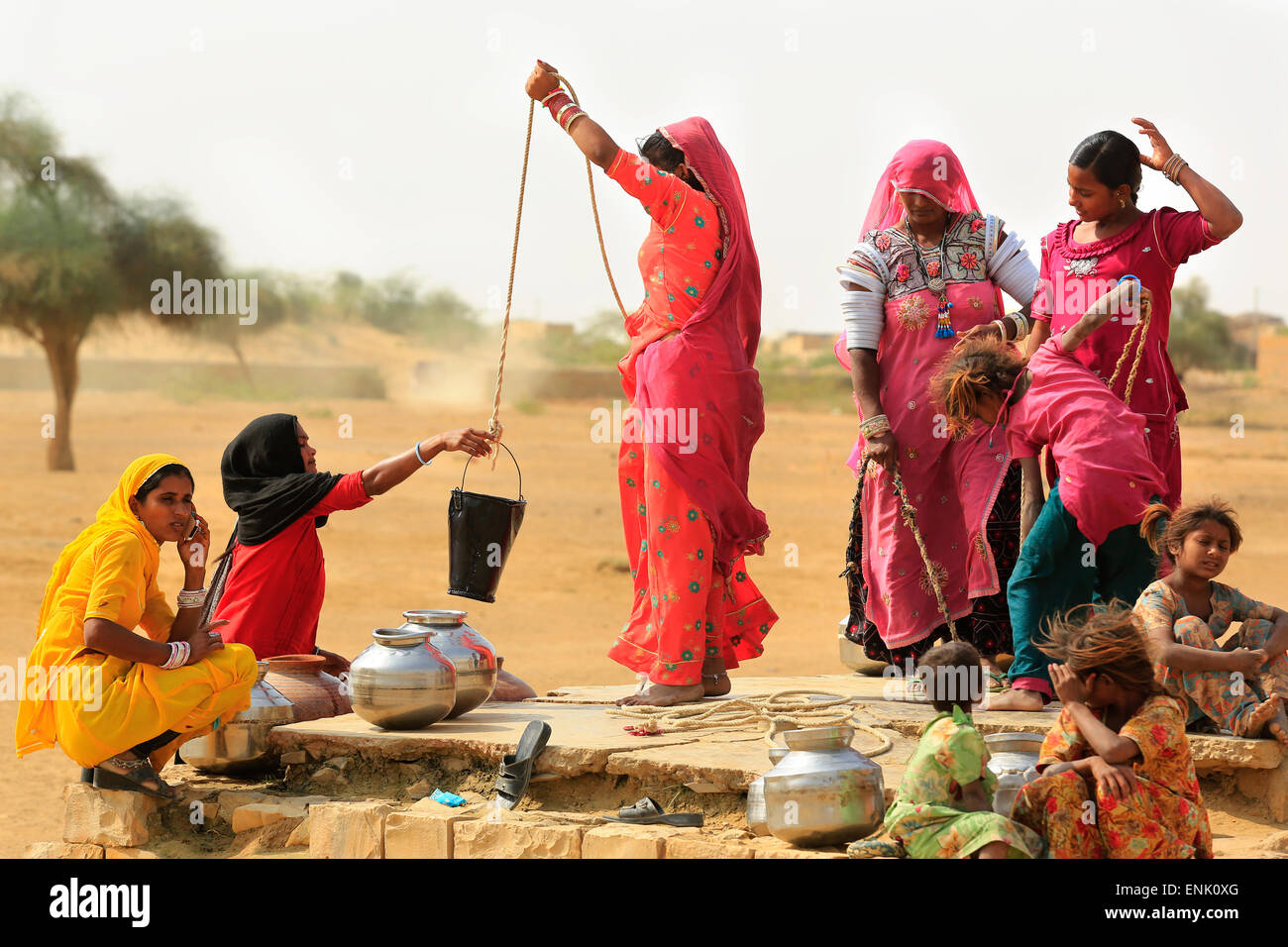 JAISALMER,INDIA - November 9,2014 : Unidentified women draw water form the well and take it to their home. Stock Photo