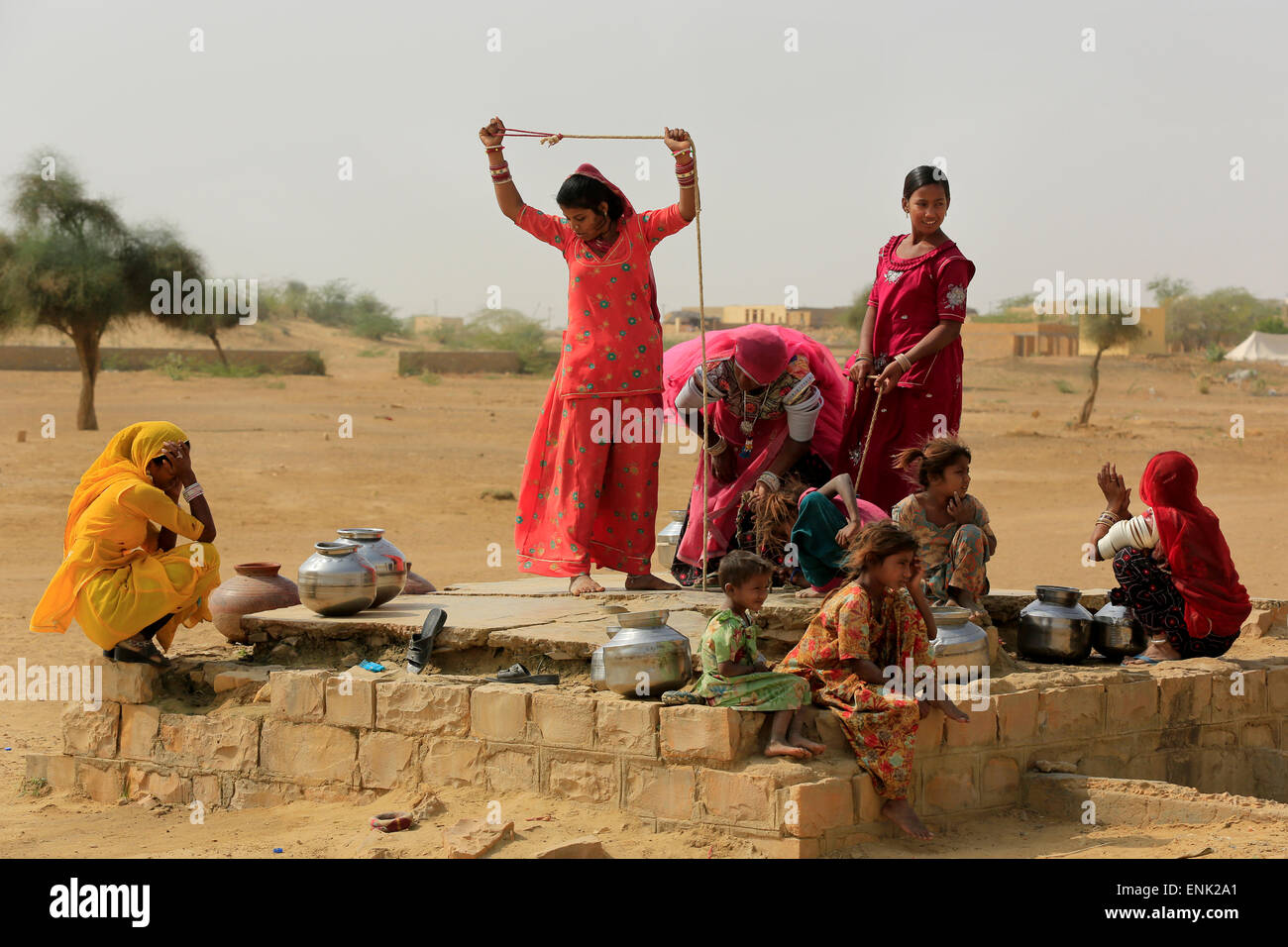 JAISALMER,INDIA - November 9,2014 : Unidentified women draw water form the well and take it to their home. Stock Photo