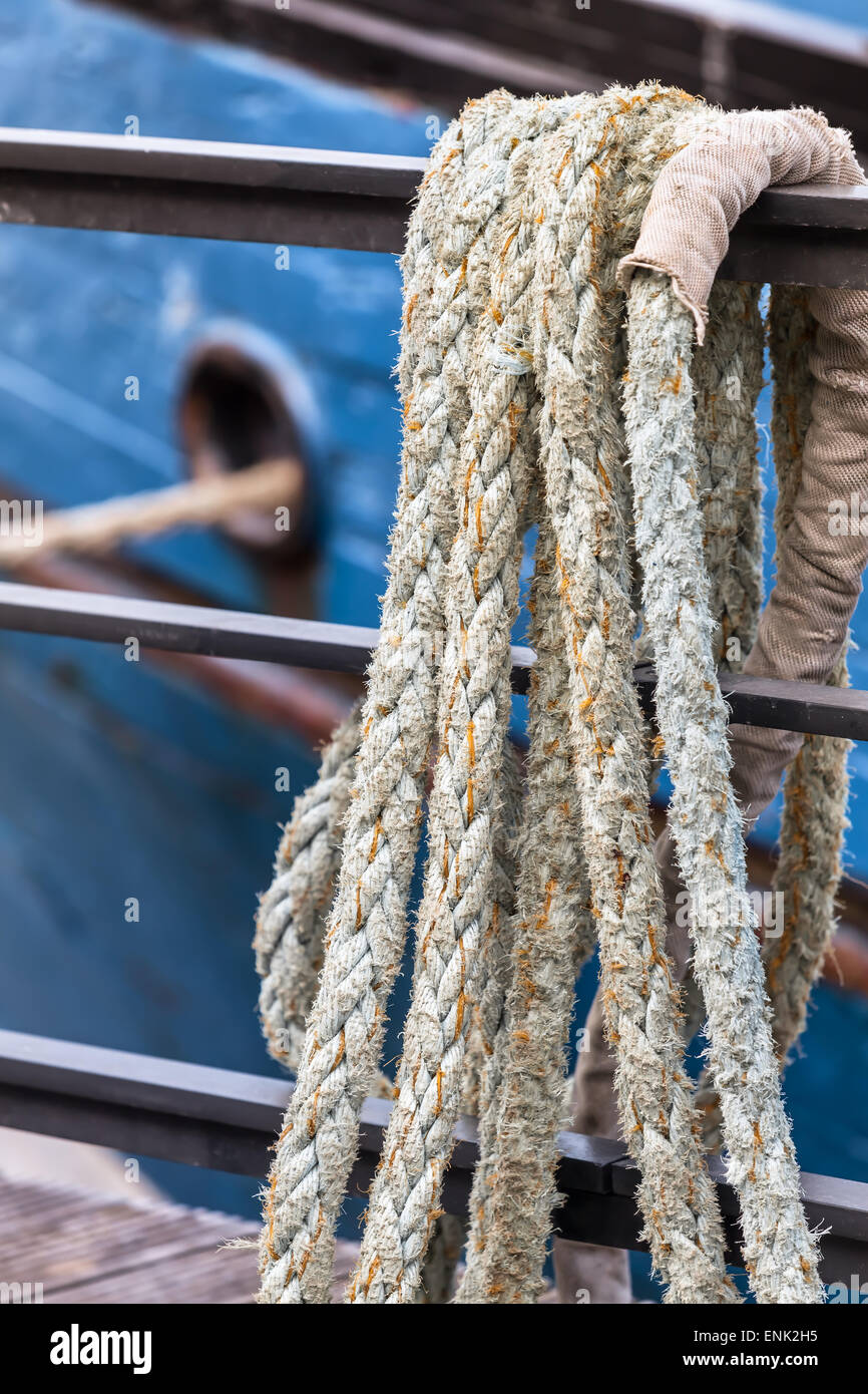 Thick rope hanging over a railing near an old ship Stock Photo - Alamy