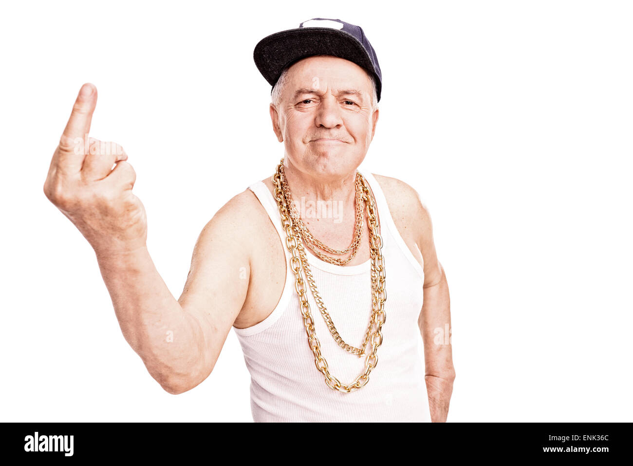 Senior man with a hip-hop cap and a golden chain, giving the finger and looking at the camera isolated on white background Stock Photo