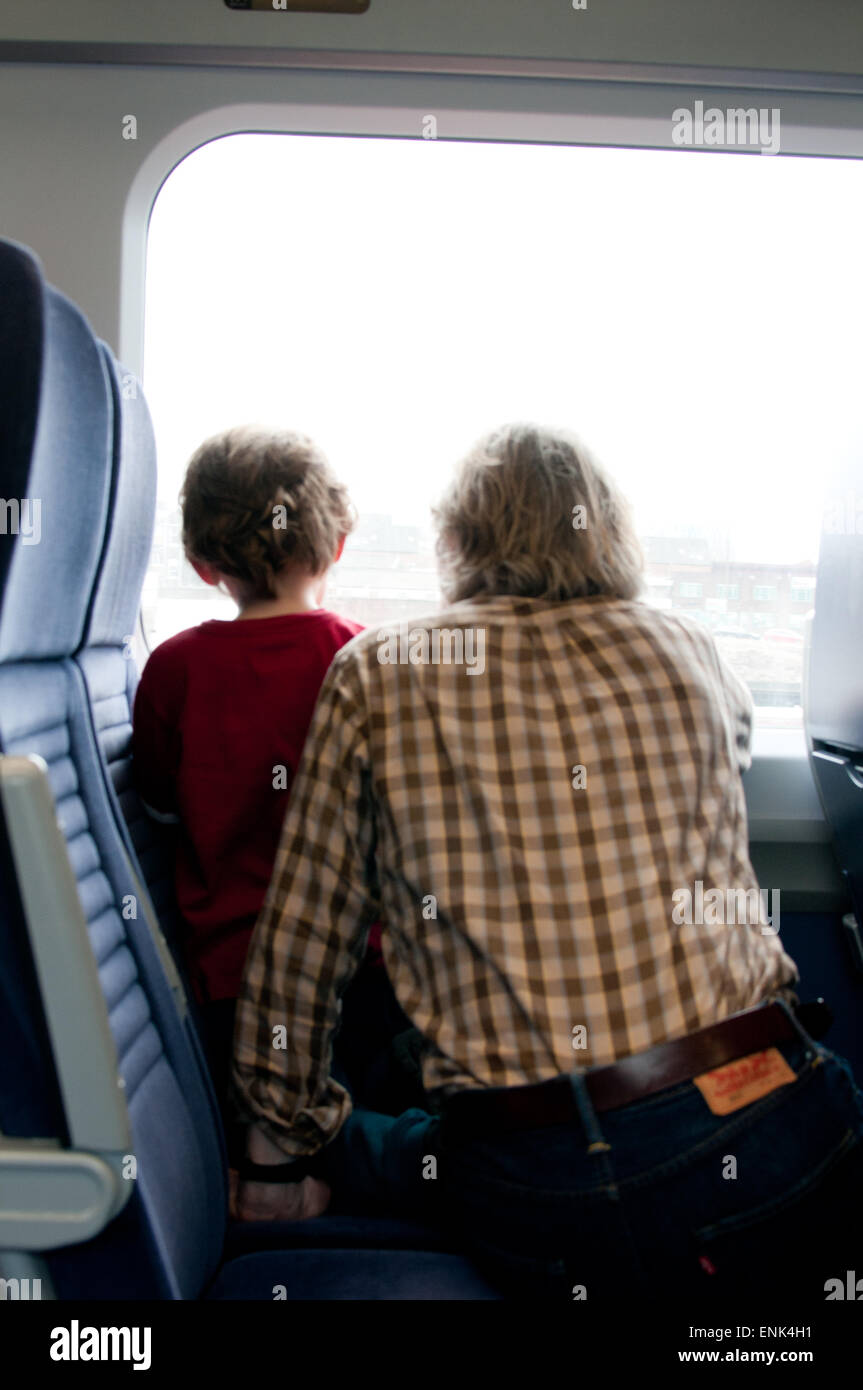 father and son at train window Stock Photo