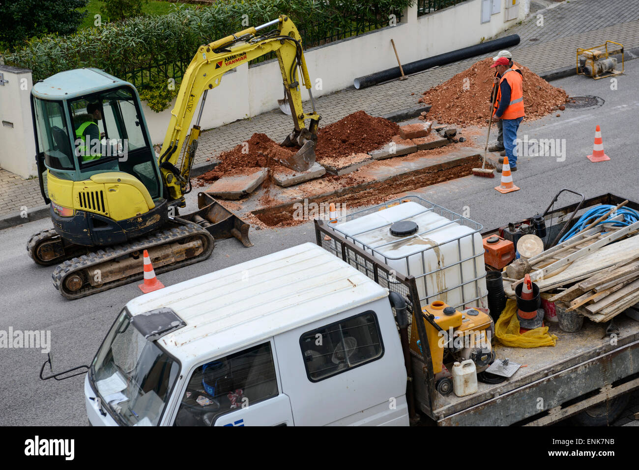 Excavator digging hole during roadworks Stock Photo