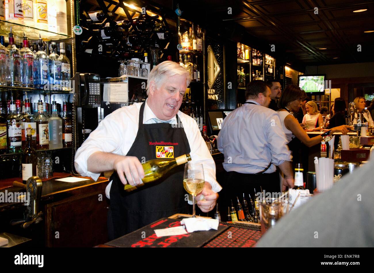 Governor of Maryland Larry Hogan steps behind the bar as a guest bartender at Harry Browns April 9, 2015 in Annapolis, Maryland. Stock Photo