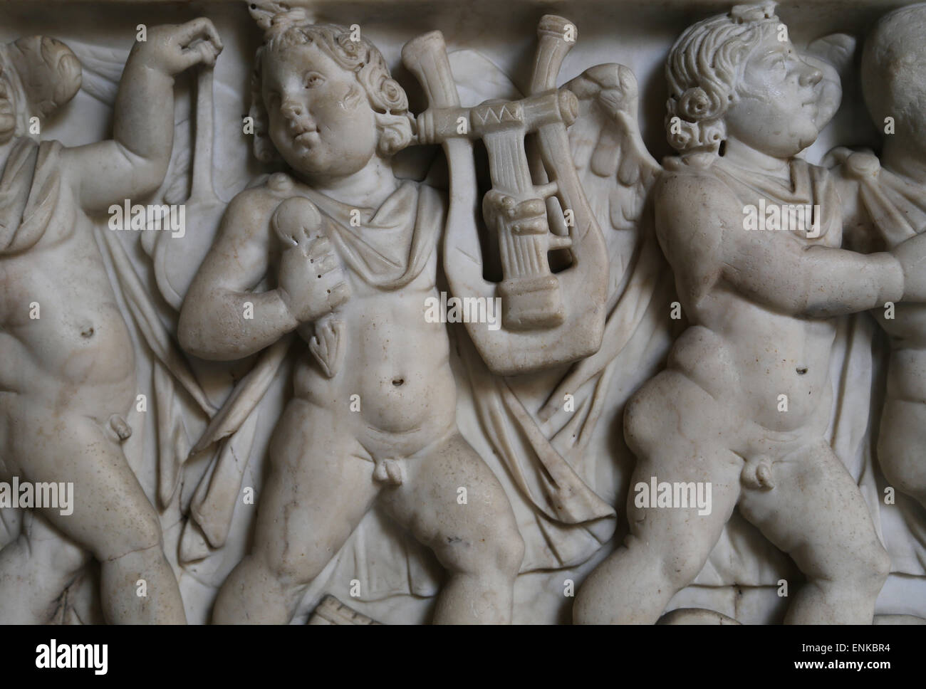 Roman art. Front panel of the sarcophagus adorned with a relief. Eros playing musicals instruments. Vatican Museums. Stock Photo