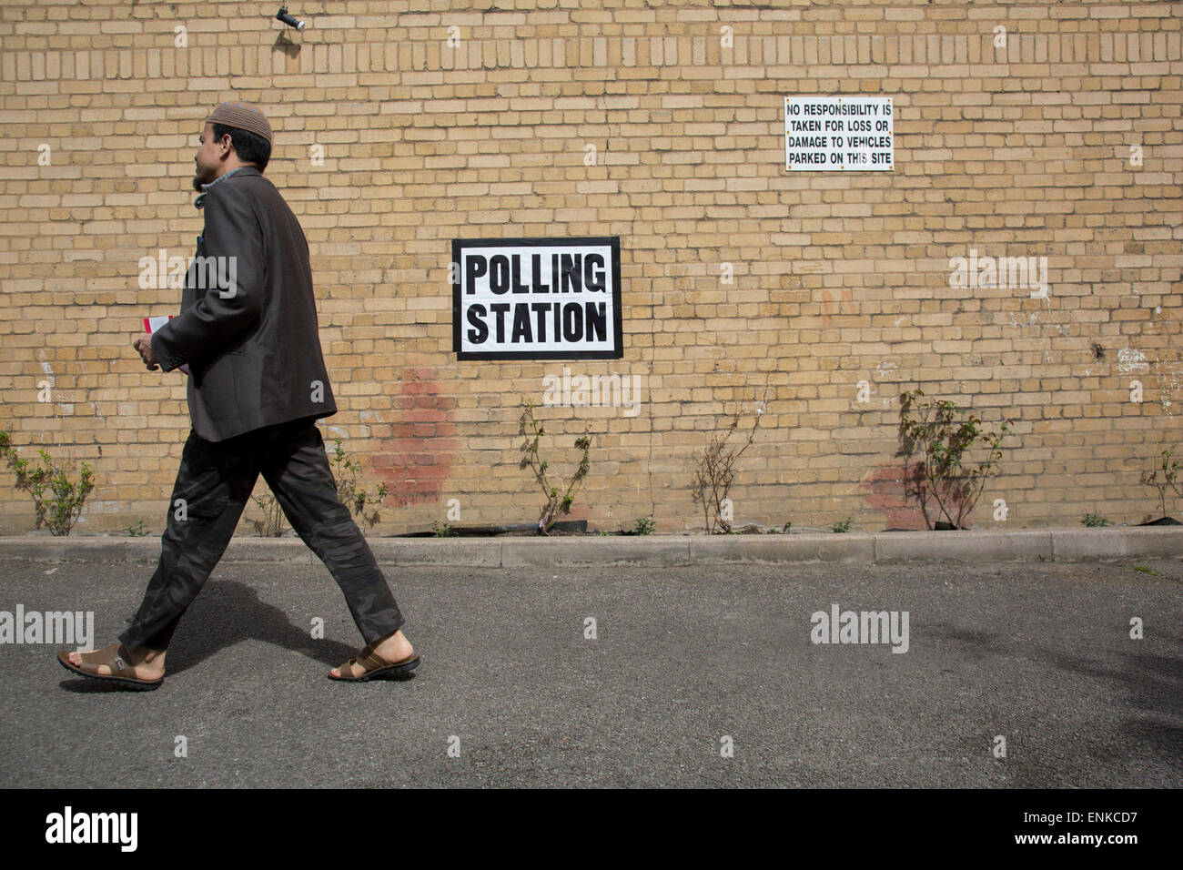 London, UK. 7th May, 2015. Voters attending a polling station at St Peter's London Docks Primary School in the constituency of  Poplar and Limehouse in East London on the day of the general election. This is a Labour Party seat, although this electin is set to be one of the most hotly contested in a generation. Credit:  Michael Kemp/Alamy Live News Stock Photo