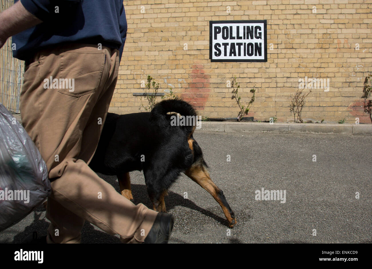 London, UK. 7th May, 2015. Voters attending a polling station at St Peter's London Docks Primary School in the constituency of  Poplar and Limehouse in East London on the day of the general election. This is a Labour Party seat, although this electin is set to be one of the most hotly contested in a generation. Credit:  Michael Kemp/Alamy Live News Stock Photo