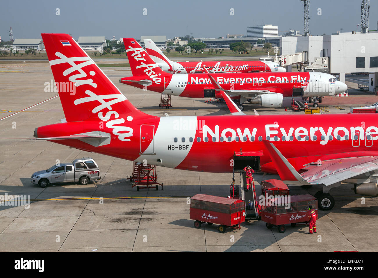 BANGKOK, THAILAND - MARCH 8, 2014: unloading of baggage from the Air Asia aircraft in Bangkok airport on March 8, 2014. Stock Photo