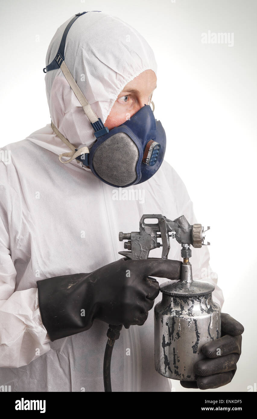 Man in protective suit, gloves, paintpistol and a respiraton Stock Photo