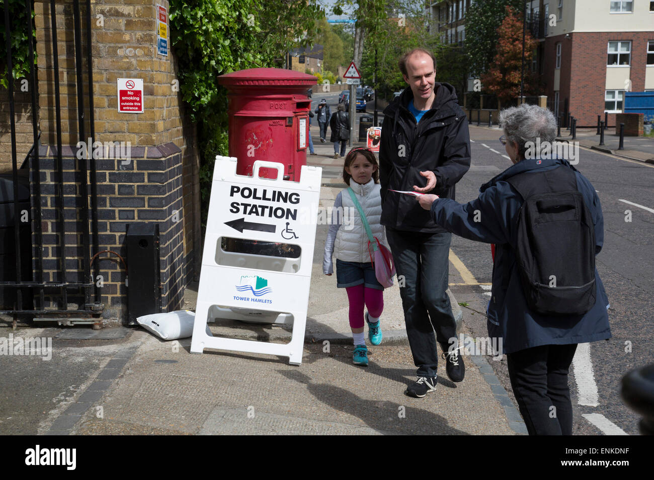 London, UK. Thursday 7th May 2015. Voters attending a polling station at St Peter's London Docks Primary School in the constituency of  Poplar and Limehouse in East London on the day of the general election. This is a Labour Party seat, although this electin is set to be one of the most hotly contested in a generation. Stock Photo