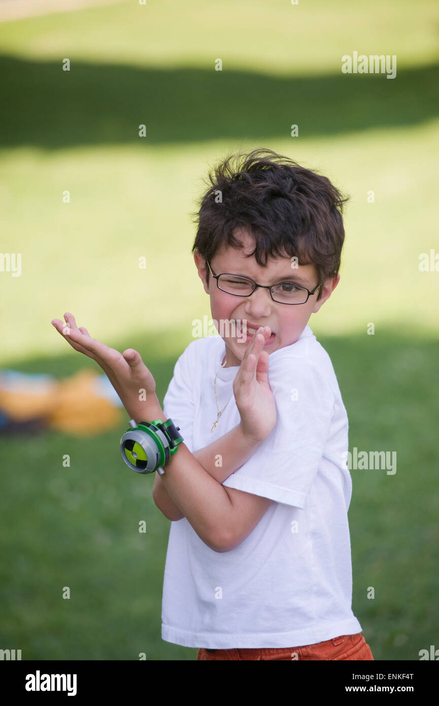 Seven year old boy proudly poses with his Ben 10 action figure watch (Child is Model released MR) Stock Photo