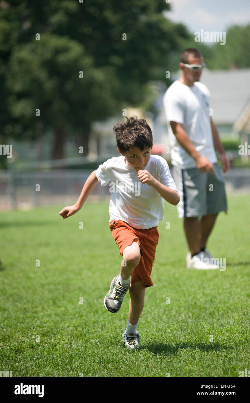 Seven year old boy sprints during soccer camp Child is Model released