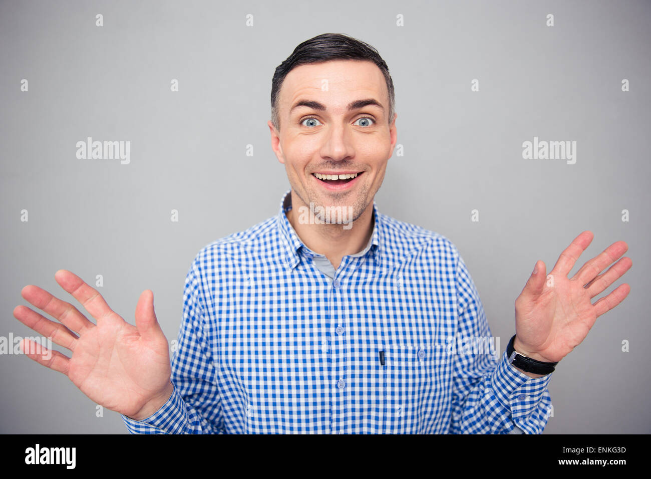 Portrait of a smiling man looking at camera over gray background Stock Photo