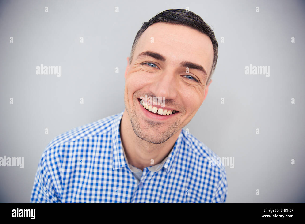 Portrait of a cheerful man looking at camera over gray background Stock Photo