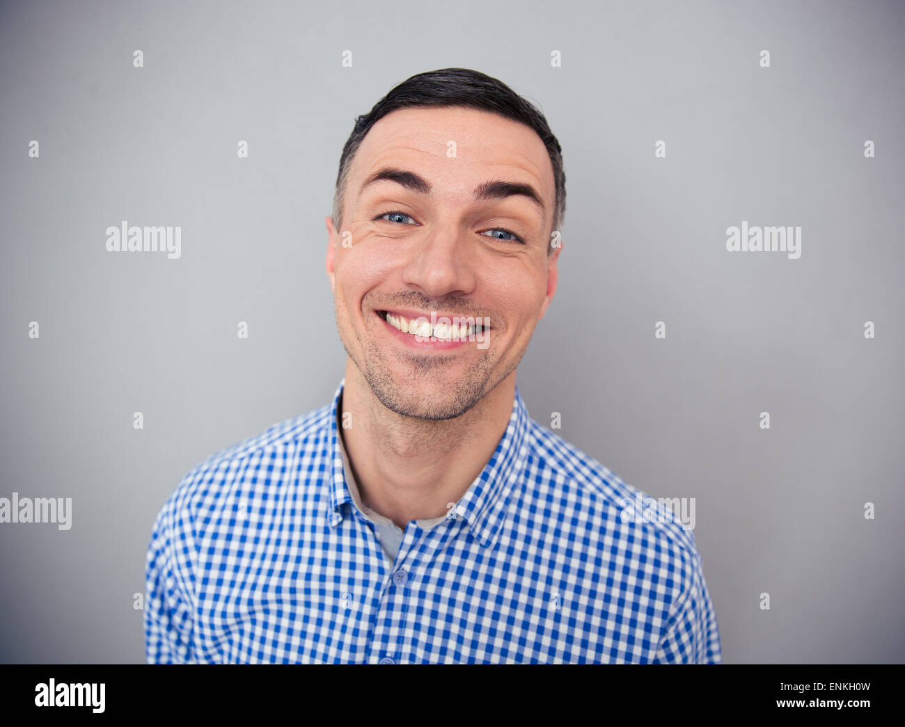 Portrait of a happiness man looking at camera over gray background Stock Photo