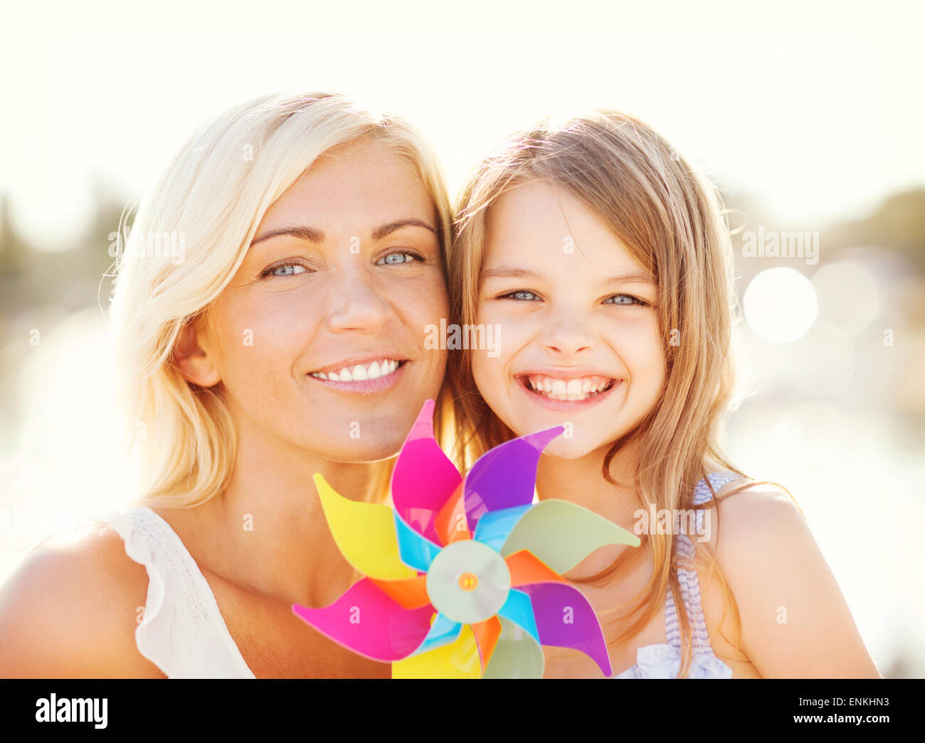 happy mother and child girl with pinwheel toy Stock Photo - Alamy