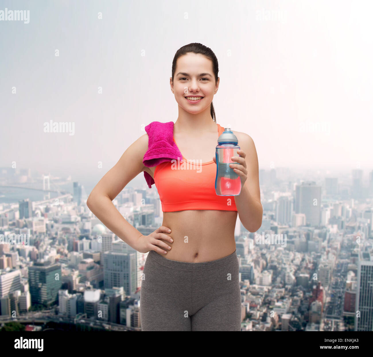 sporty woman with towel and water bottle Stock Photo - Alamy