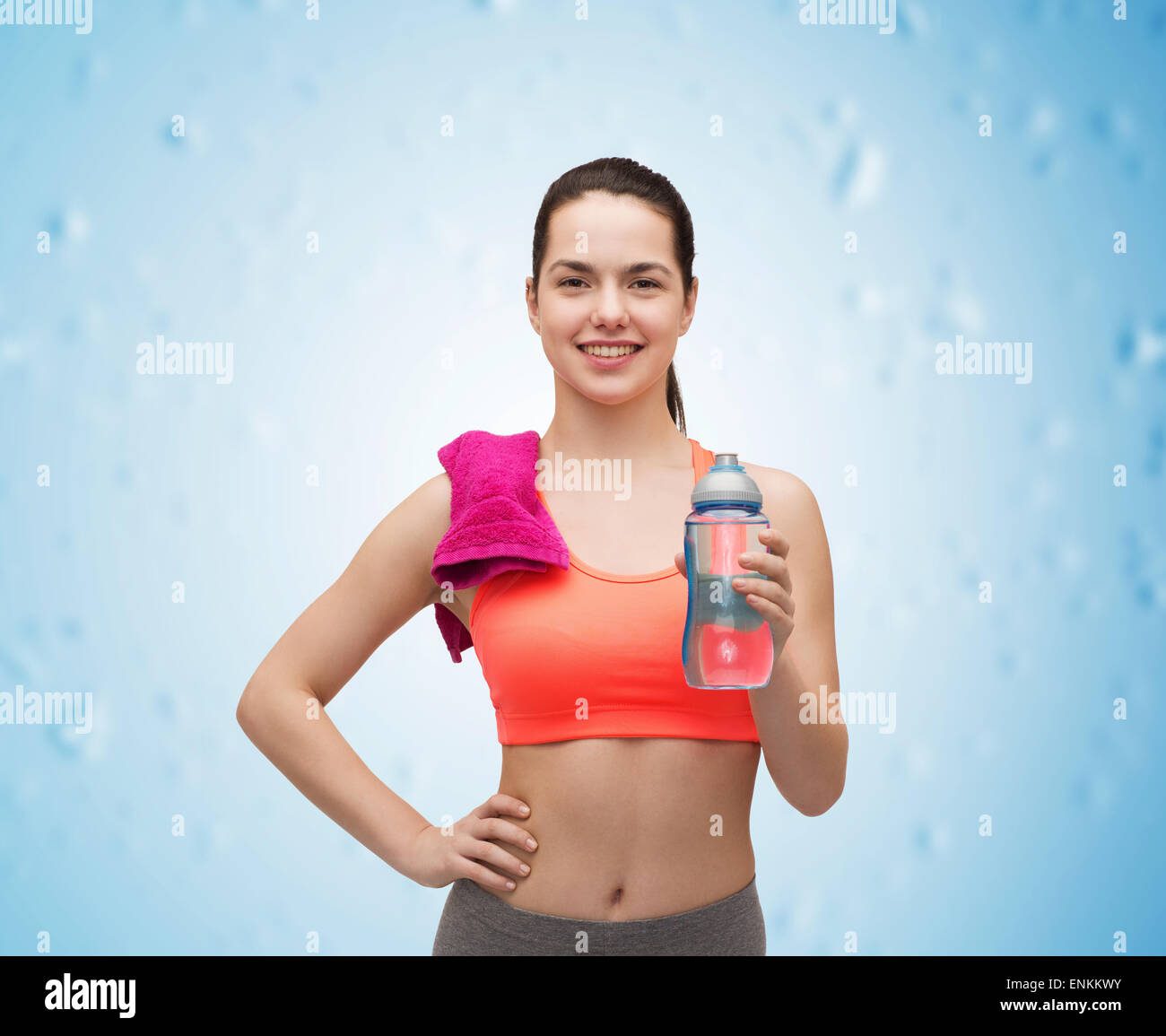sporty woman with towel and water bottle Stock Photo - Alamy