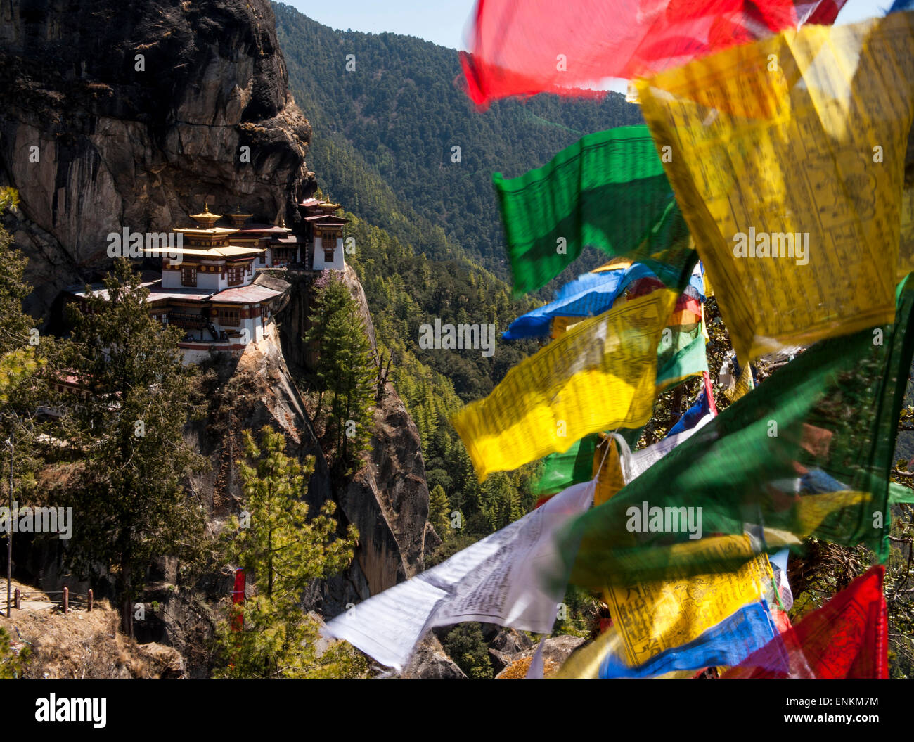 View of Taktsang or Tiger's Nest Monastery and prayer flags Paro Valley Bhutan Stock Photo