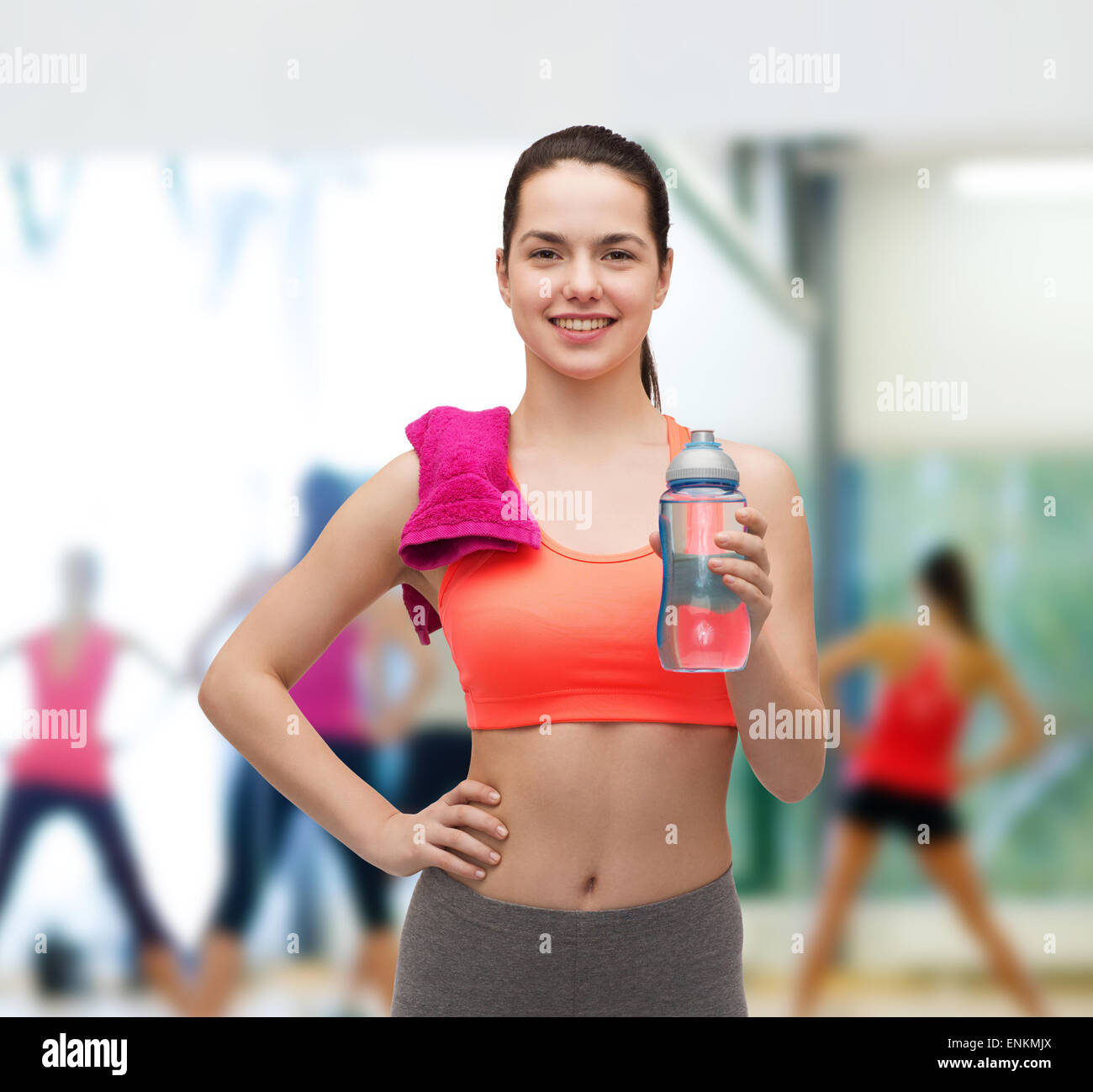 sporty woman with towel and water bottle Stock Photo - Alamy