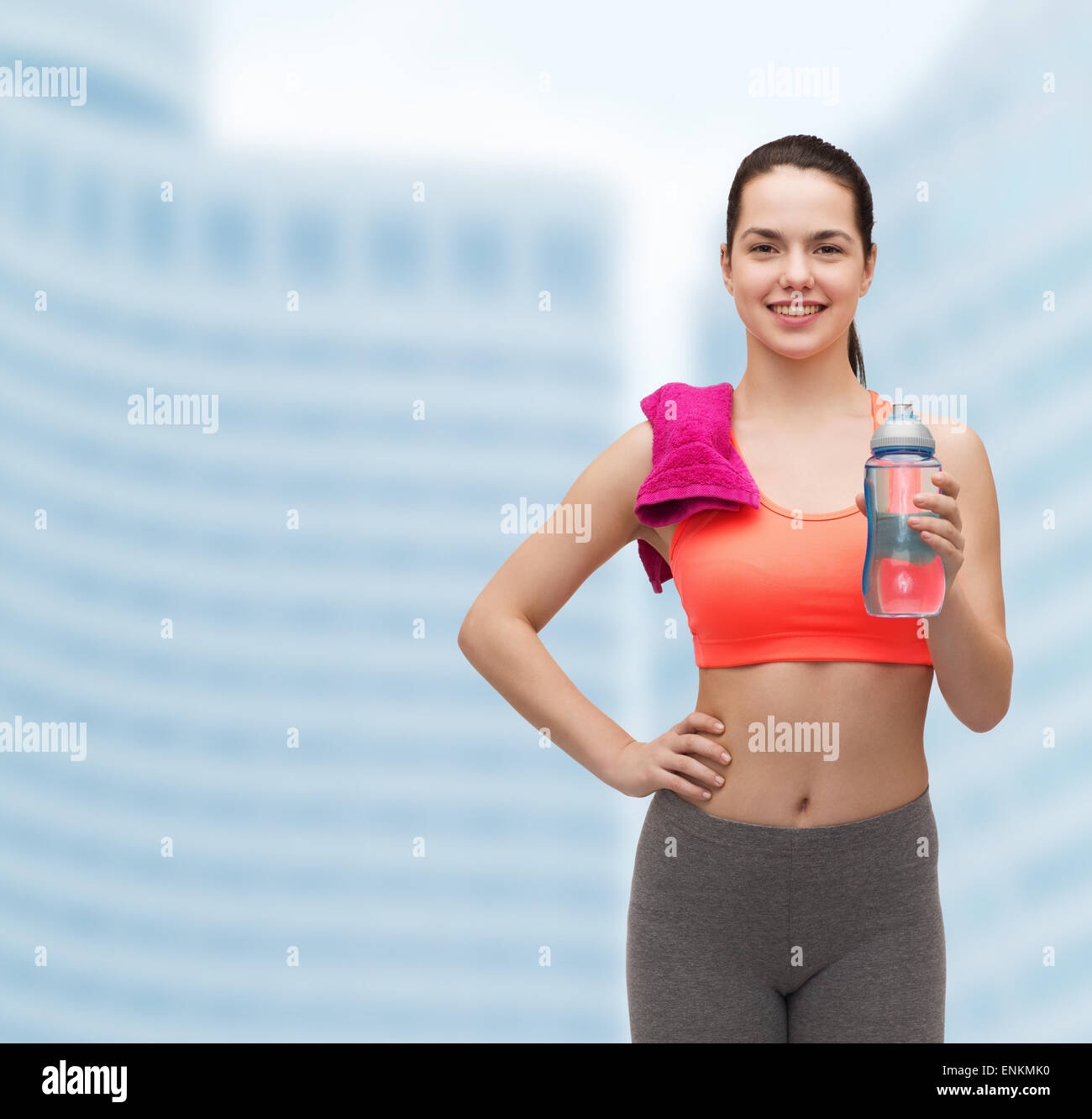 sporty woman with towel and water bottle Stock Photo - Alamy
