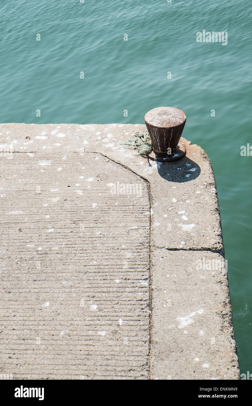 Bollard on the edge of a harbour pier Stock Photo