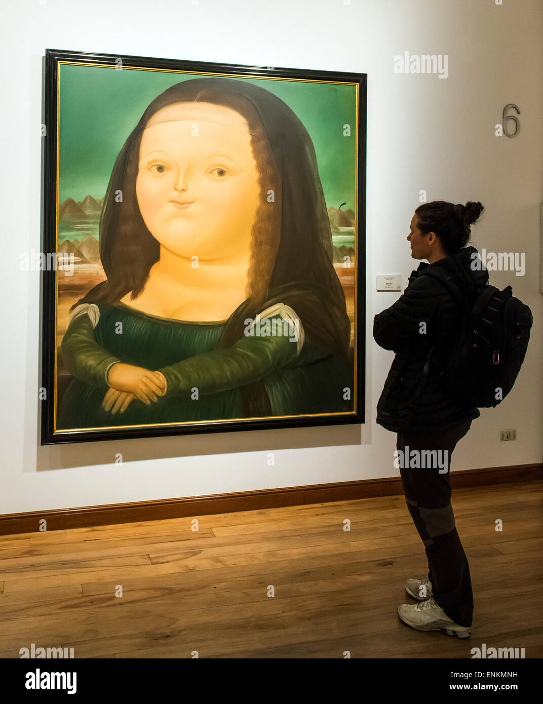 Woman standing by Mona Lisa Monalisa painting by Fernando Botero at Botero Museum Bogota Colombia Stock Photo