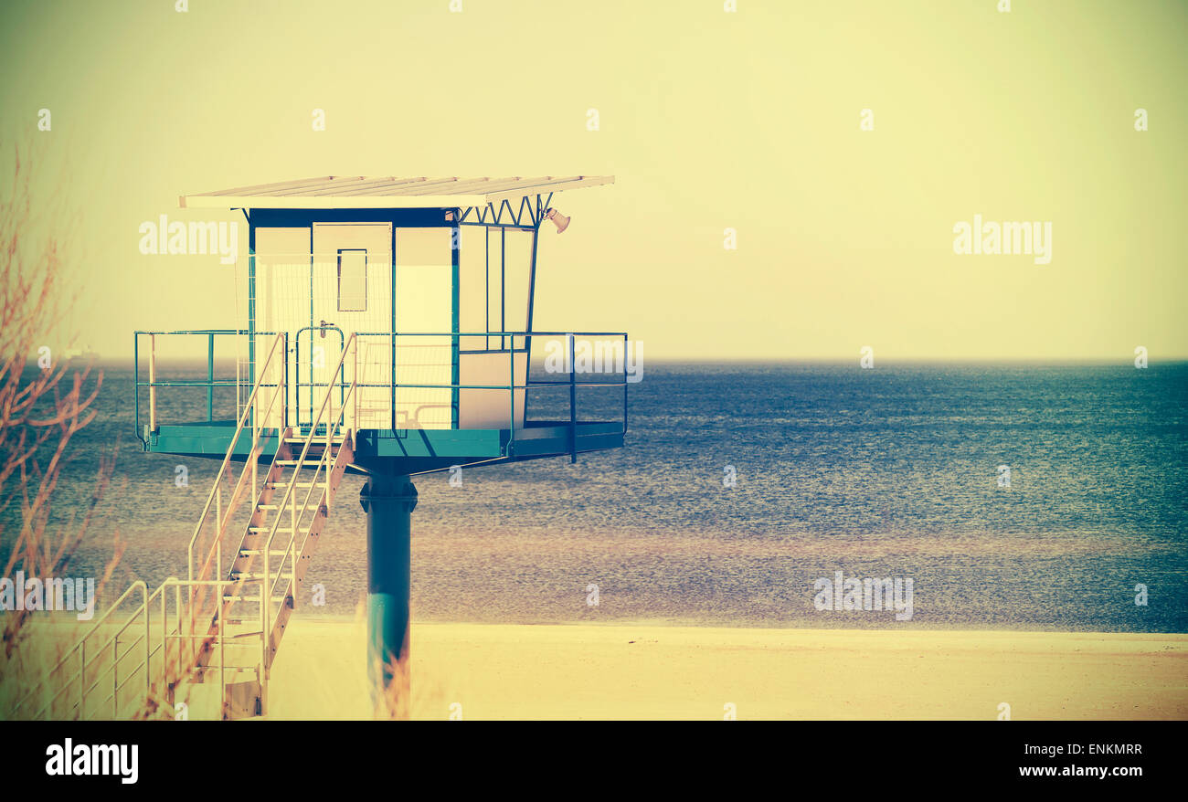 Retro cross process style filtered picture of a lifeguard tower on a beach. Stock Photo