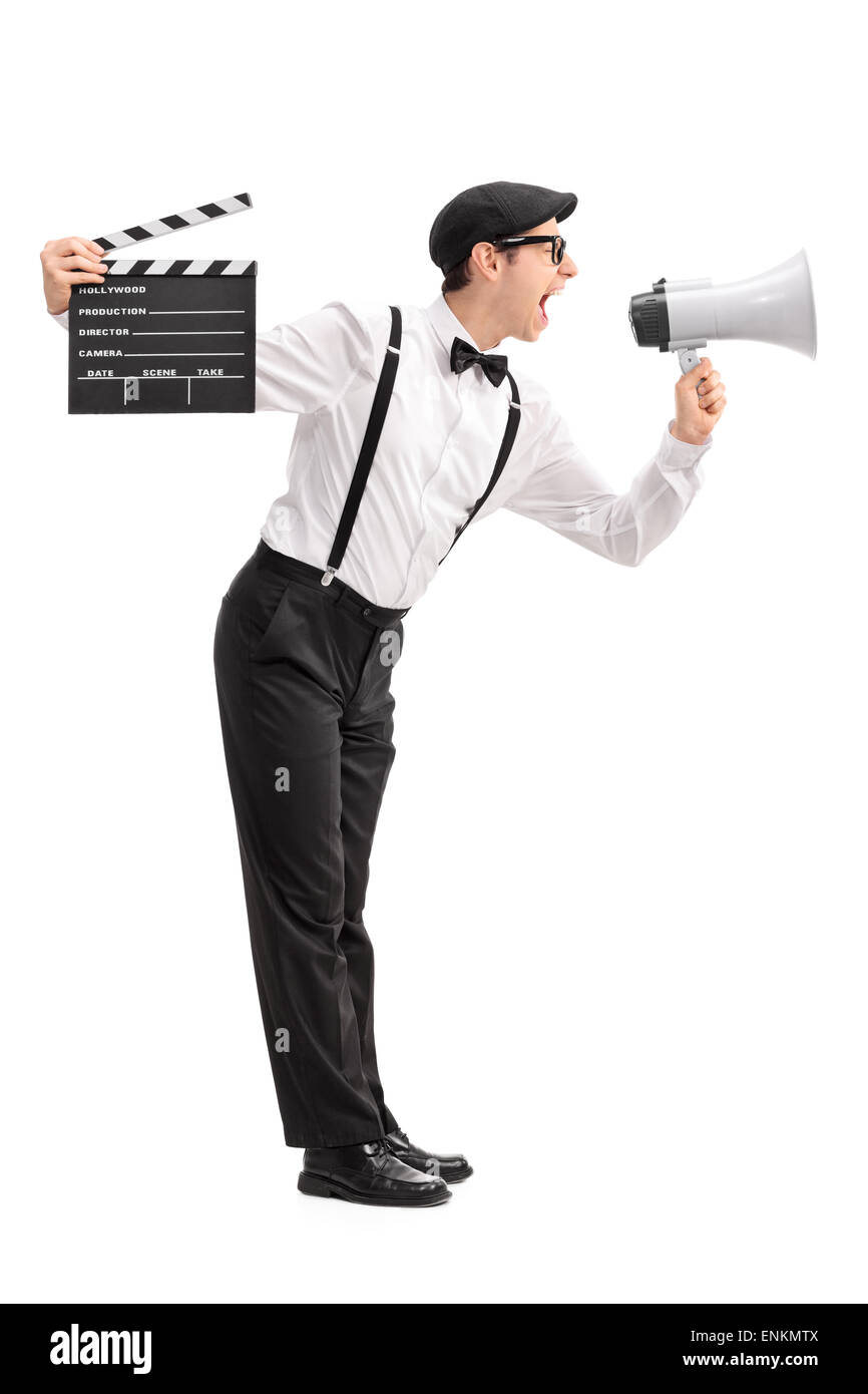 Full length profile shot of a young movie director holding a
