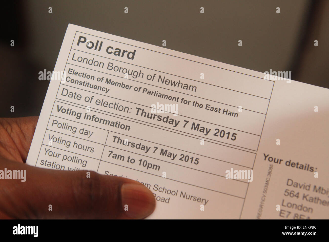 London, UK. 6th May, 2015. A London borough of Newham voter hold a Polling card ahead of the Thursday 7 May UK elections. Britain's two-party system appears under severe threat, with the distinct prospect that between them Labour and the Conservatives will struggle to gain two-thirds of the votes cast. Compare that with their near 90% vote share just 50 years ago. Credit:  david mbiyu/Alamy Live News Stock Photo