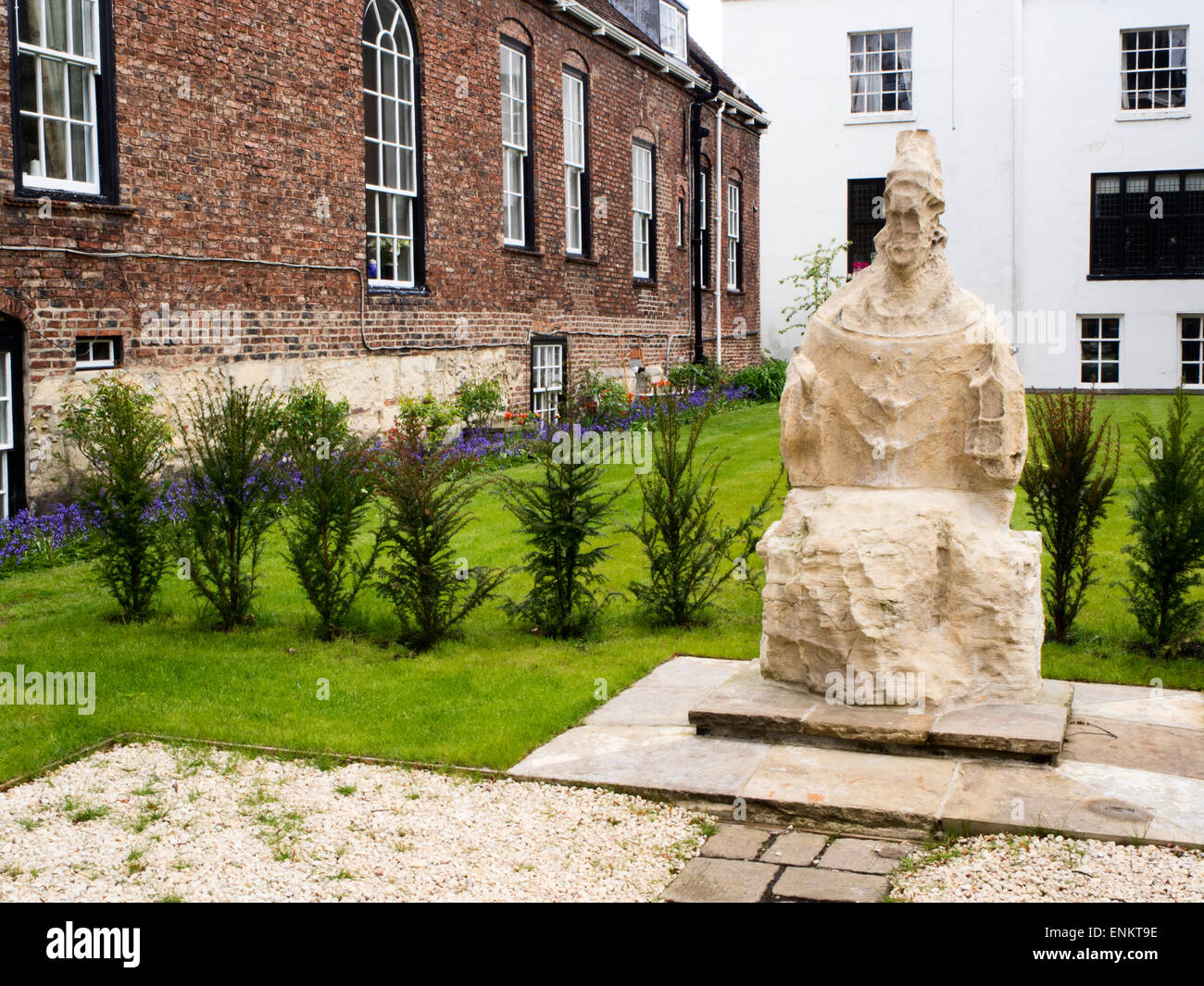 The Seated Figure Statue in a Garden on Minster Yard York Yorkshire England Believed to be St Peter and formerly at the apex of Stock Photo