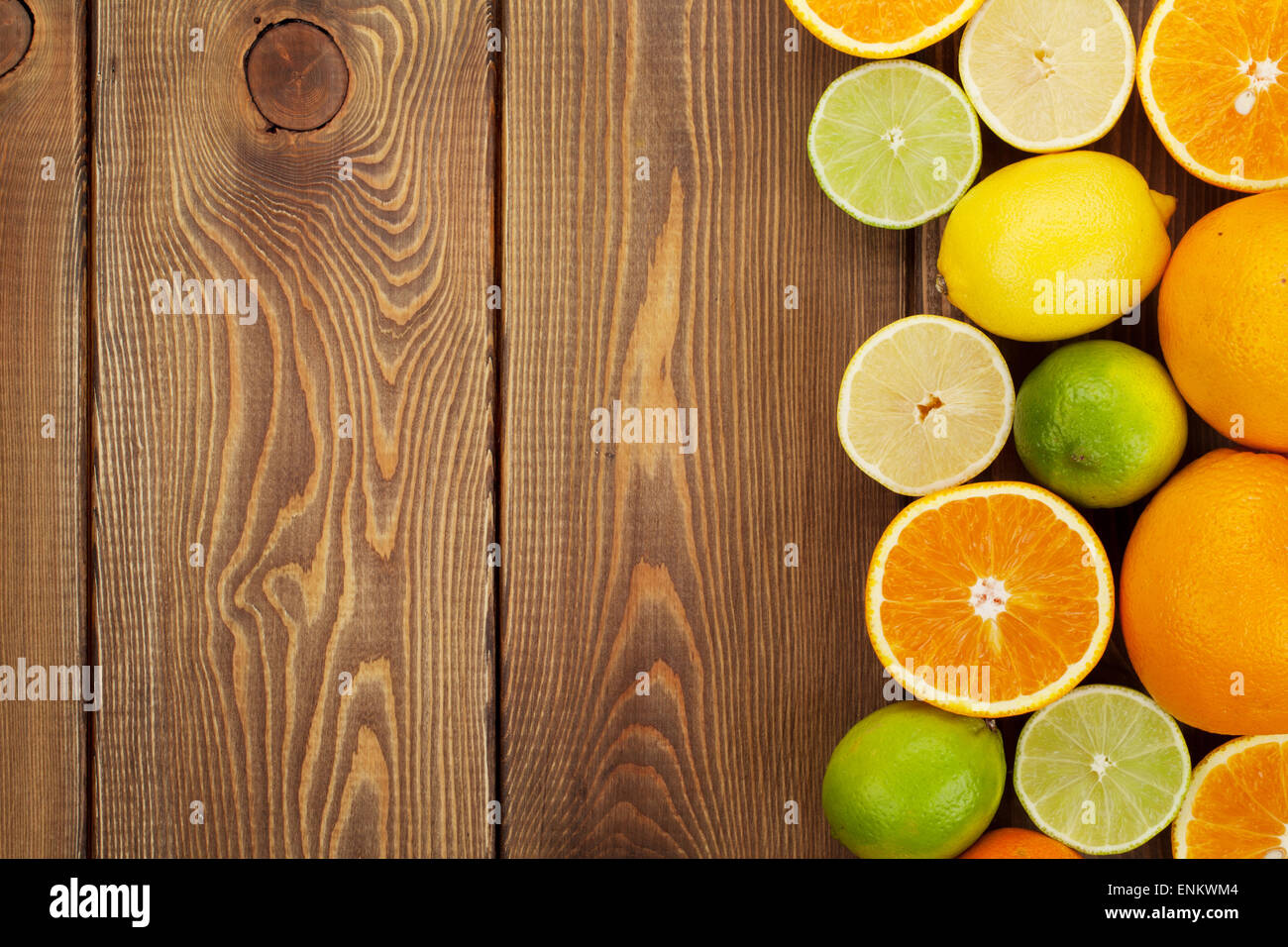 Citrus fruits. Oranges, limes and lemons. Over wooden table background ...