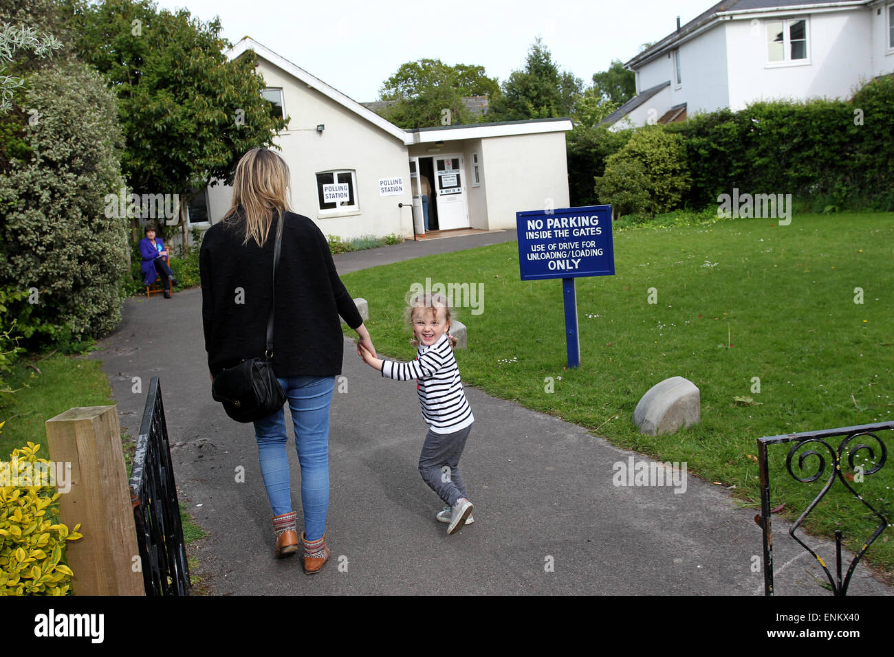 Chichester, Sussex, UK. 7th May, 2015. Kelly Davis, a young mother with her three-year-old daughter Isabelle, pictured at a polling station in the Conservative safe seat of Chichester, casting her vote in the General Election 2015. St Michaels Hall, Chichester, West Sussex, UK. 07/05/15 Credit:  Chloe Parker/Alamy Live News Stock Photo