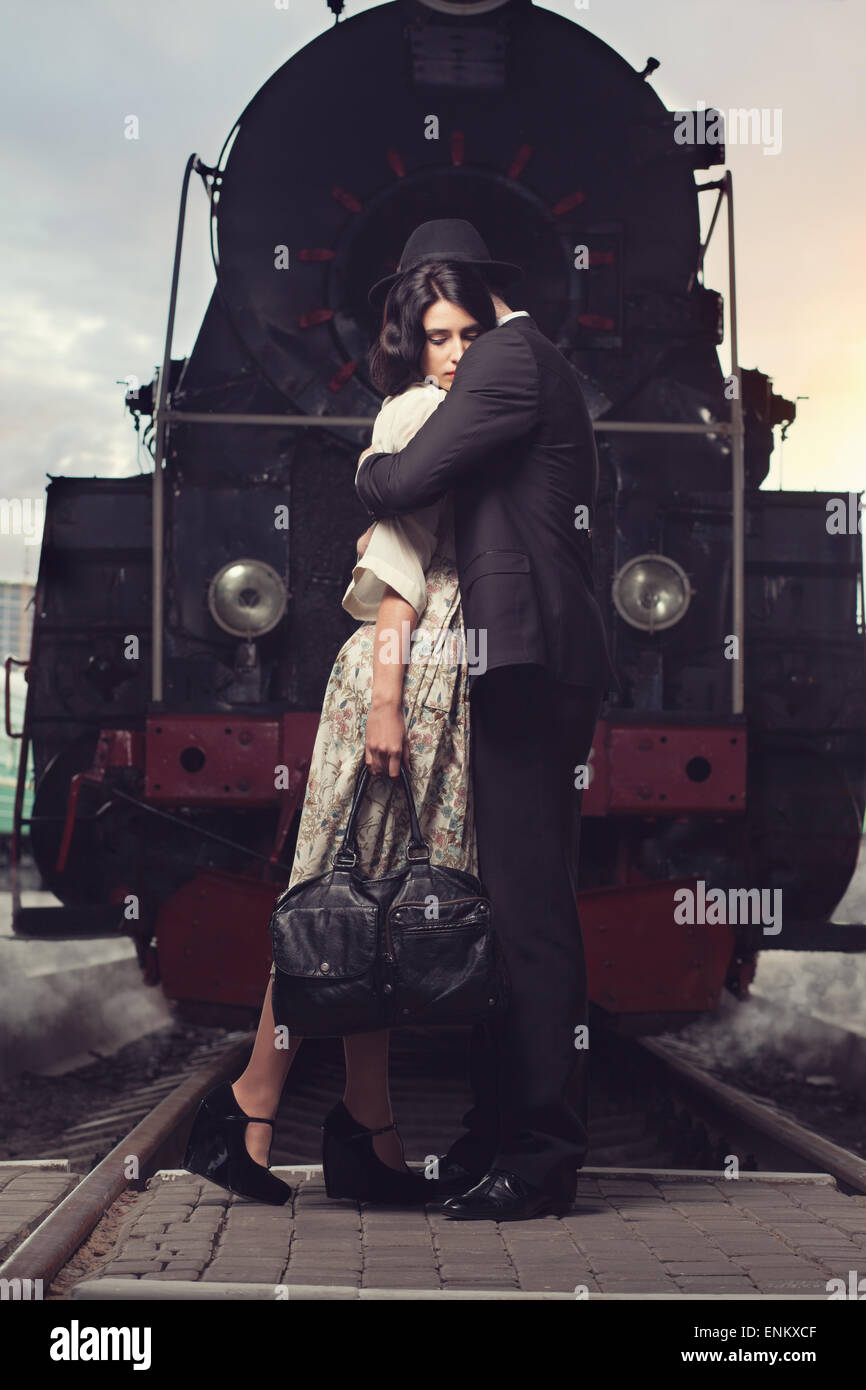 parting of lovely couple on railway station at locomotive background ...