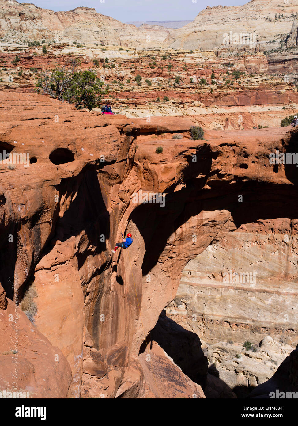 Spectators watch a climber. Scene from Cassidy Arch, Capitol Reef National Park, Utah. Stock Photo