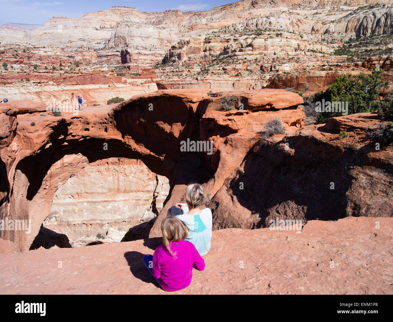 Spectators watch a climber. Scene from Cassidy Arch, Capitol Reef National Park, Utah. Stock Photo