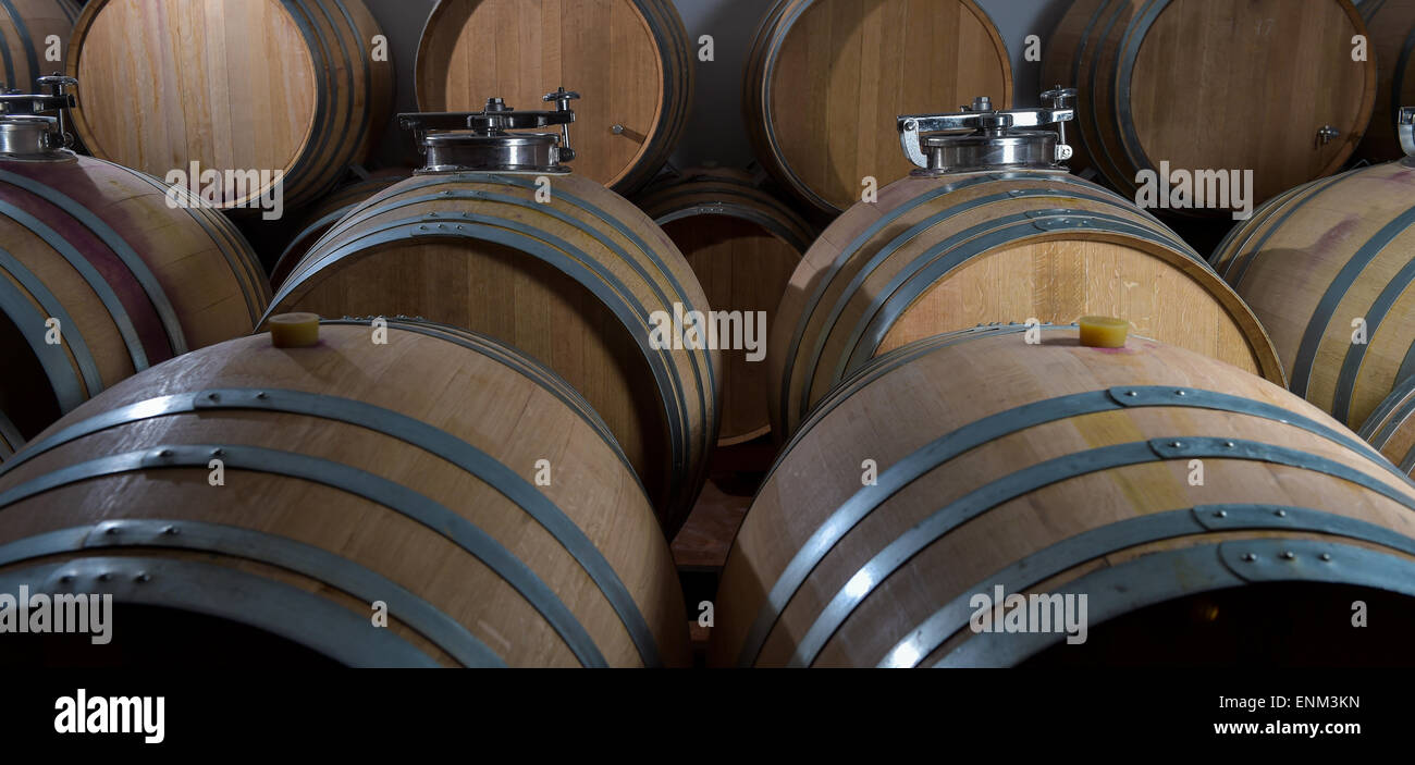 Wine barrels stacked in cellar, Bordeaux Vineyard, France Stock Photo