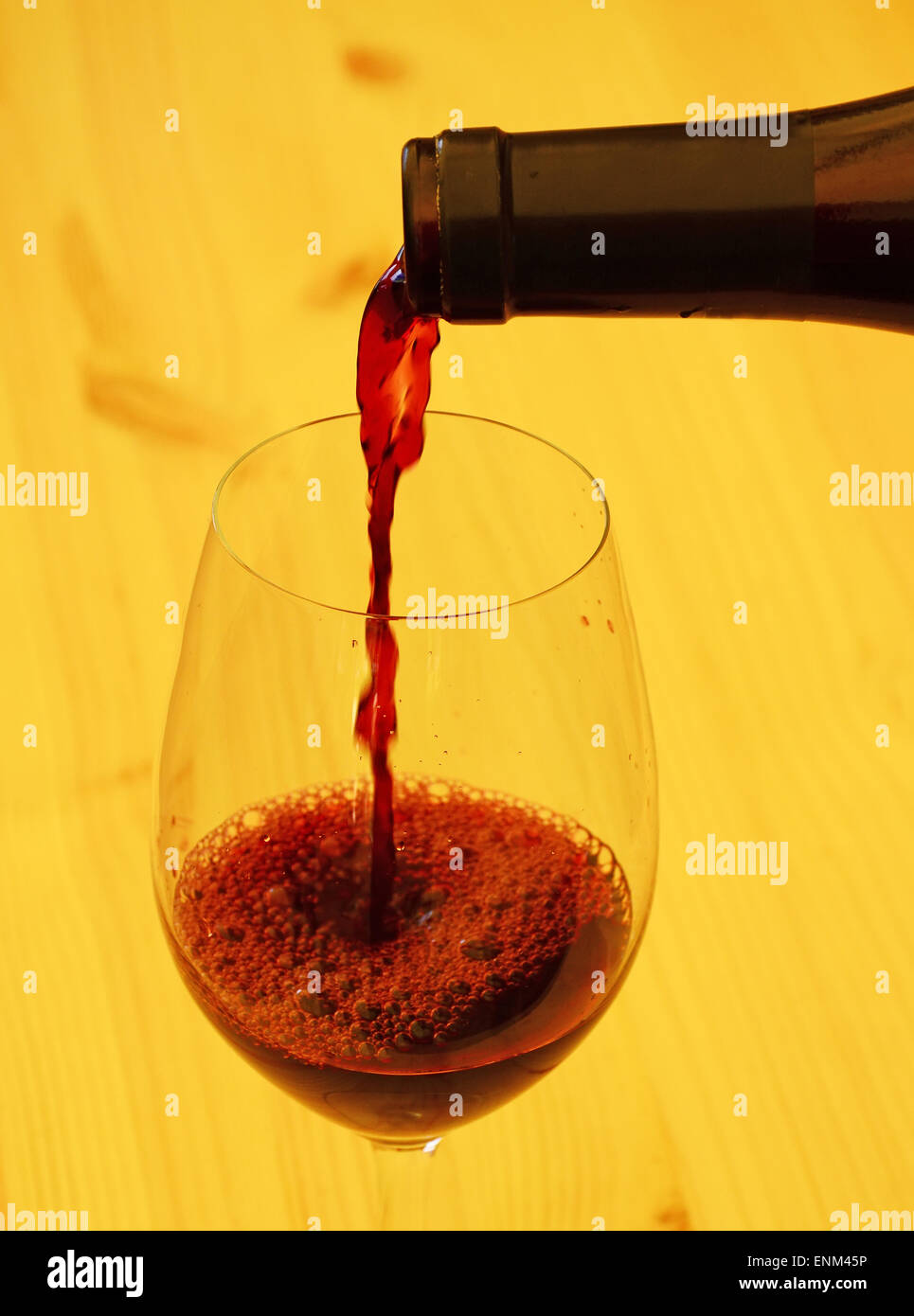Red wine poured into wine glass Stock Photo