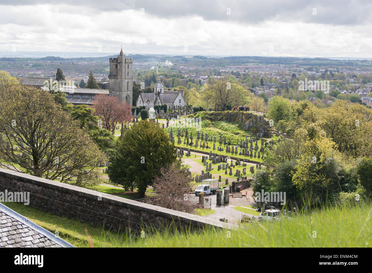 View from Stirling Castle of a group of tourists standing on top of The Ladies Rock, Old Town Cemetery Stock Photo