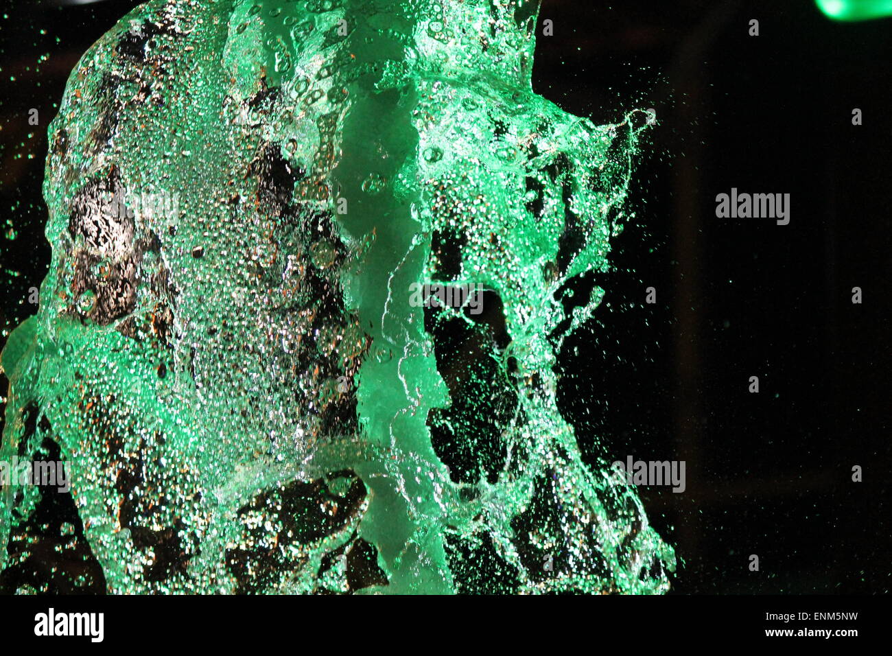 Fountain water splashing by lights at night Stock Photo Alamy