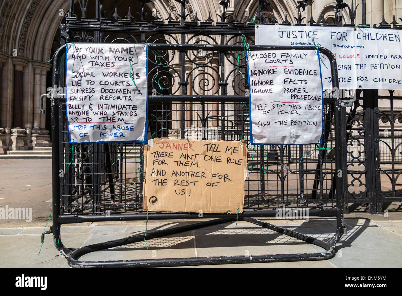 Handwritten protest placards outside the Royal Courts of Justice (law courts), Strand, London WC2 Stock Photo
