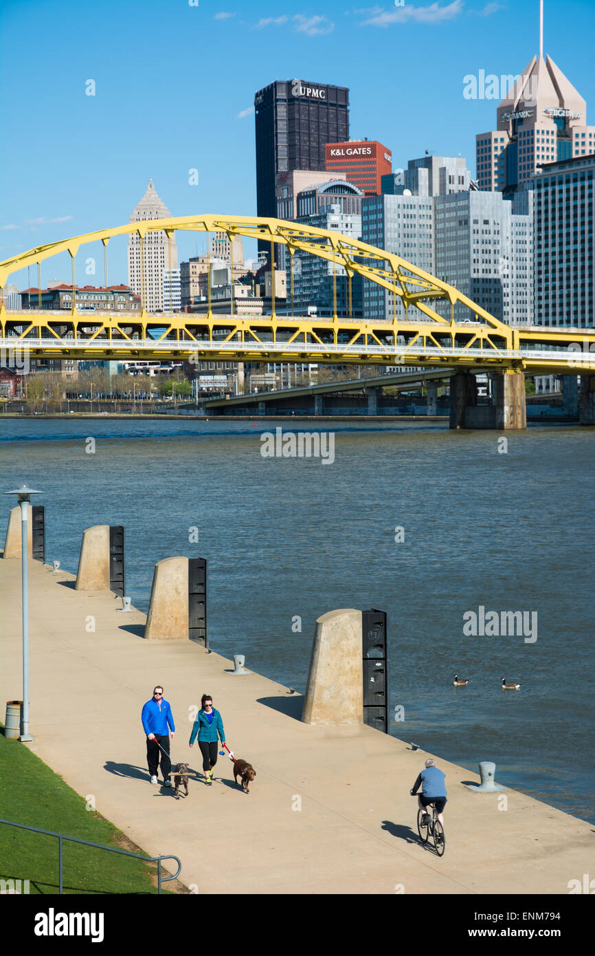 People walk and bike along the Three Rivers Heritage Trail on the North Shore of Pittsburgh, Pennsylvania. Stock Photo