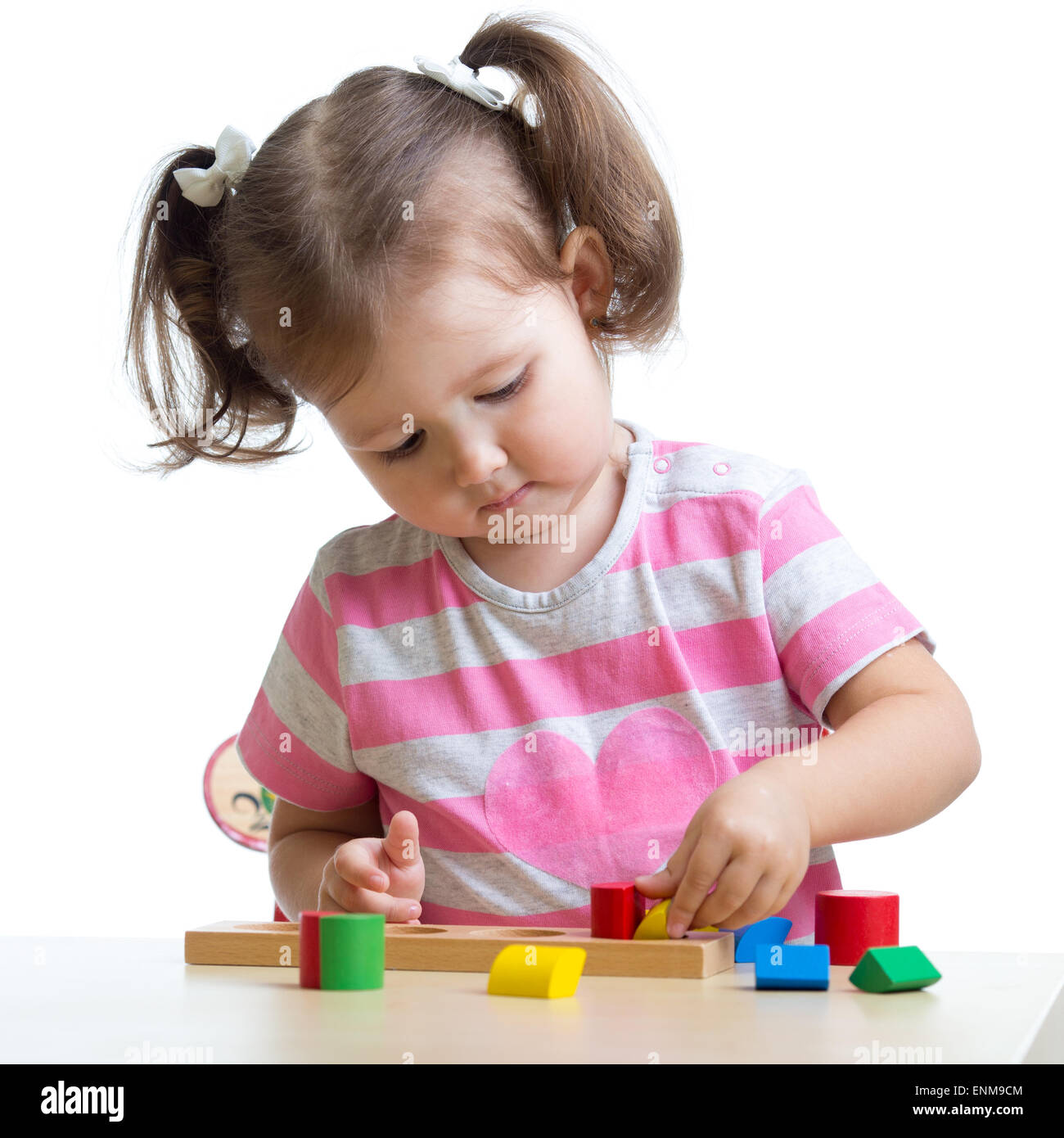 little child girl playing with puzzle toys isolated Stock Photo - Alamy