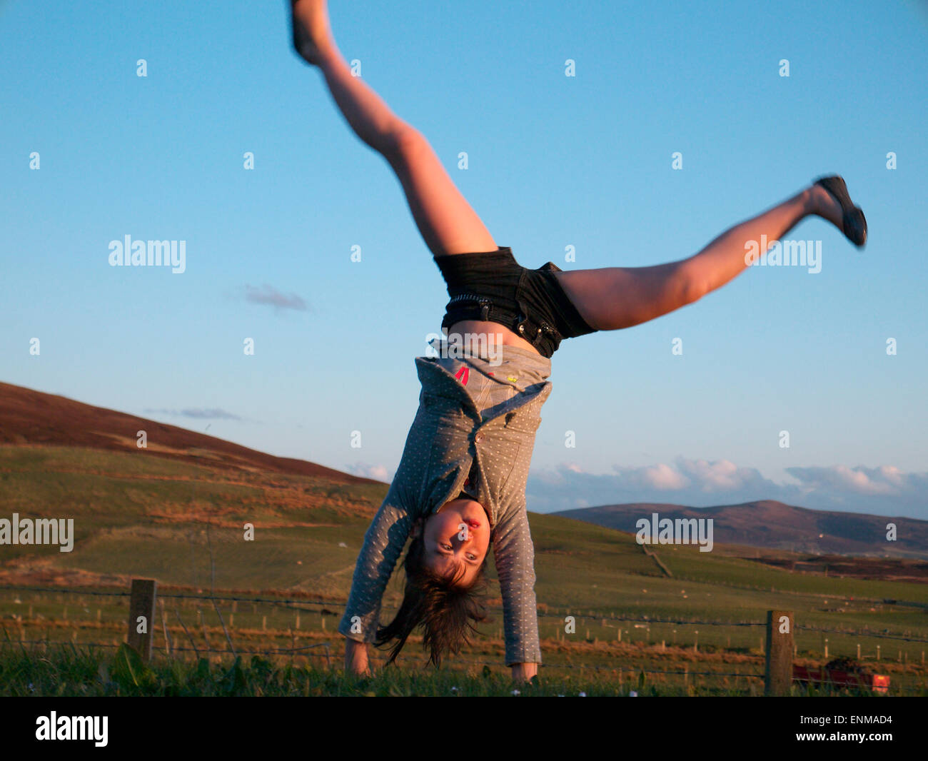 Girl performing a cartwheel Stock Photo