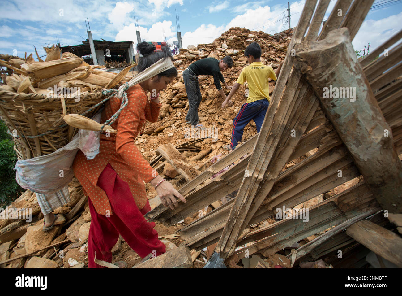 Residents dig through the rubble of their homes in Sindhulpalchowk District, Nepal following the 2015 earthquake. Stock Photo