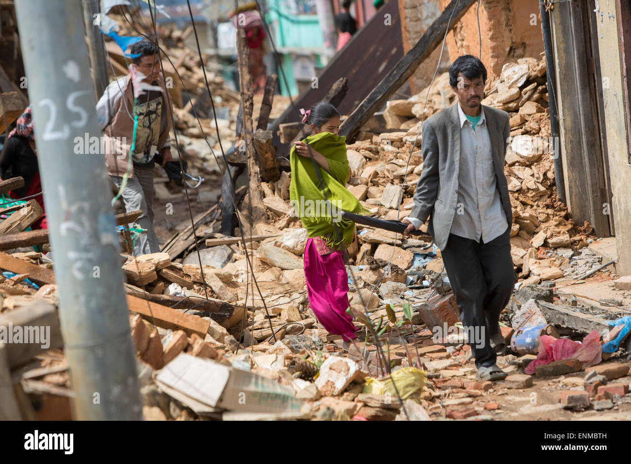 Residents walk through the streets of Chautara town in Sindhulpalchowk District, Nepal following the 2015 earthquake. Stock Photo