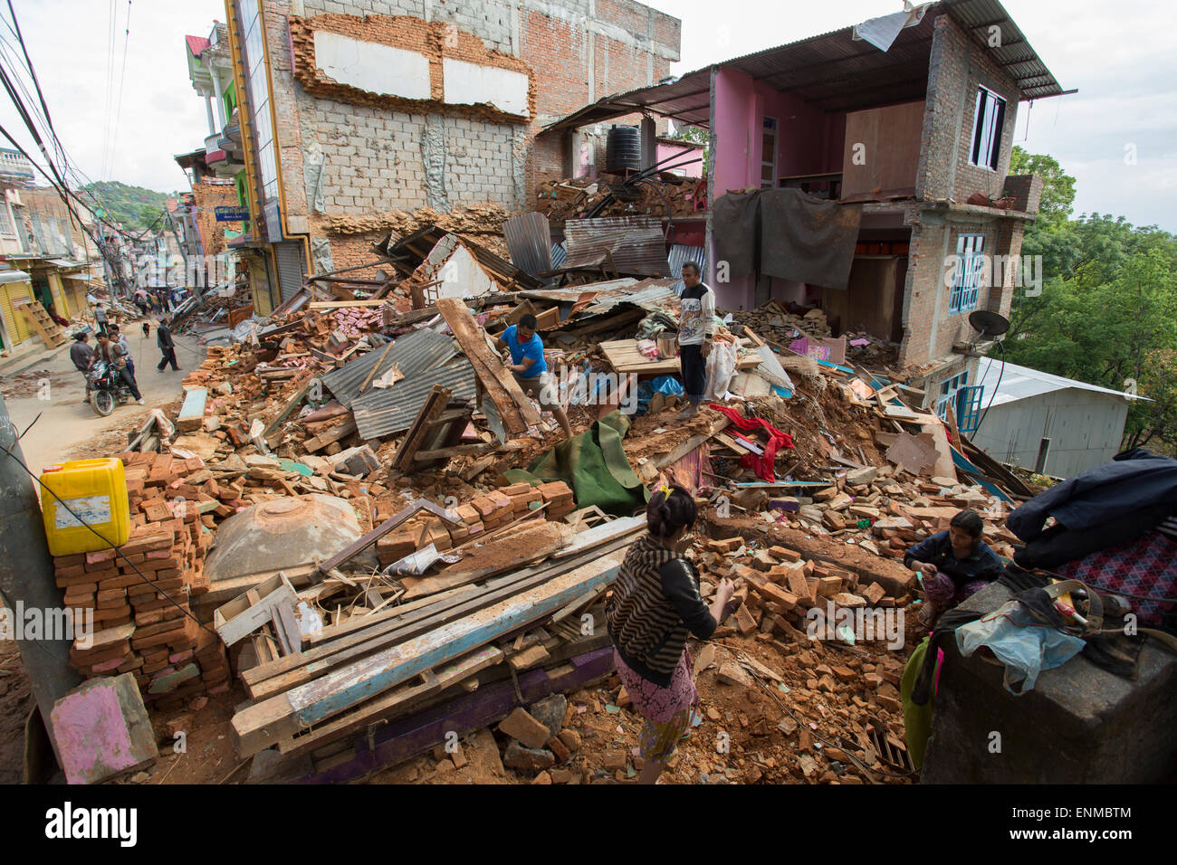 Residents of Chautara town dig through the rubble of their homes in Sindhulpalchowk District, Nepal following the 2015 earthquake. Stock Photo