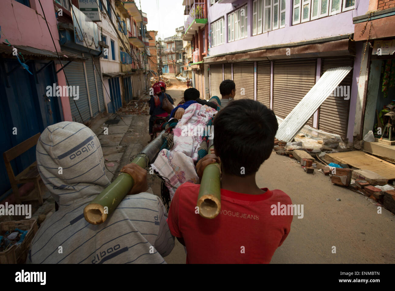 A victim is carried out of a collapsed building in Sindhulpalchowk District, Nepal following the 2015 earthquake. Stock Photo